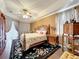 Elegant bedroom with tray ceilings, a decorative rug, and ornate furniture at 1473 Lakemist Ln, Clermont, FL 34711