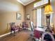 Home office features wood floors, natural light, a large desk, and comfortable seating at 1473 Lakemist Ln, Clermont, FL 34711