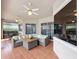Outdoor patio with dining and lounge areas, ceiling fans, pool, and sliding glass doors at 1473 Lakemist Ln, Clermont, FL 34711