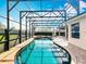 Enclosed pool with hot tub is surrounded by brick and covered for privacy at 1473 Lakemist Ln, Clermont, FL 34711