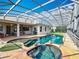 Enclosed pool includes a hot tub and manicured areas, next to the home's patio at 1473 Lakemist Ln, Clermont, FL 34711