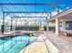 Enclosed pool and lanai include patio seating and lounging for outdoor relaxation at 1473 Lakemist Ln, Clermont, FL 34711