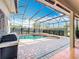 Enclosed pool features a hot tub, surrounding brick, and a well-equipped outdoor grill at 1473 Lakemist Ln, Clermont, FL 34711