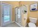 Bathroom featuring walk-in shower with glass door and access to the pool area at 1473 Lakemist Ln, Clermont, FL 34711