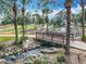 Scenic stream with a charming wooden bridge, rock features, and lush greenery alongside the golf course at 1473 Lakemist Ln, Clermont, FL 34711