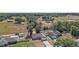 Scenic view of a home with a long driveway, neighboring property, and abundant greenery at 15117 Se 94Th Ter, Summerfield, FL 34491