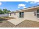 Backyard with a concrete patio and sliding glass door, perfect for outdoor entertaining at 15117 Se 94Th Ter, Summerfield, FL 34491