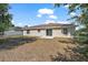 Backyard featuring lush greenery, a concrete patio, and ample space for outdoor activities at 15117 Se 94Th Ter, Summerfield, FL 34491