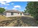 Spacious backyard featuring a concrete patio and lush greenery, ideal for outdoor living at 15117 Se 94Th Ter, Summerfield, FL 34491