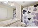Bathroom featuring a white vanity, toilet, and Mickey Mouse themed shower curtain at 15117 Se 94Th Ter, Summerfield, FL 34491