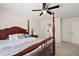 Spacious primary bedroom suite with a four-poster bed frame and ensuite bathroom at 15117 Se 94Th Ter, Summerfield, FL 34491