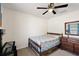 Cozy bedroom featuring a ceiling fan and a wooden bed frame with comfortable bedding at 15117 Se 94Th Ter, Summerfield, FL 34491