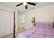 Comfortable bedroom with a bed, ceiling fan, and ample closet space at 15117 Se 94Th Ter, Summerfield, FL 34491