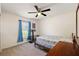 Bedroom with a ceiling fan, bright window, and neutral carpet at 15117 Se 94Th Ter, Summerfield, FL 34491