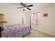 Bedroom features a four poster bed, ceiling fan, and natural light from the window at 15117 Se 94Th Ter, Summerfield, FL 34491