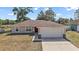 Charming home featuring a two-car garage, stone accents, and well-maintained landscaping at 15117 Se 94Th Ter, Summerfield, FL 34491
