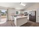 Well-lit kitchen featuring a center island, stainless steel refrigerator, and ample counter space at 15117 Se 94Th Ter, Summerfield, FL 34491