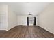 Spacious living room featuring wood-look floors, a window, and a white door at 15117 Se 94Th Ter, Summerfield, FL 34491