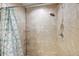 Nicely tiled shower with a showerhead and shower curtain, great for a relaxing bath at 15117 Se 94Th Ter, Summerfield, FL 34491