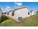 Exterior view of the home showcasing the well-maintained backyard with lush green grass at 1622 Navidad St, The Villages, FL 32162