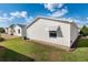 Exterior home view highlighting the backyard with manicured lawn and clean property lines at 1622 Navidad St, The Villages, FL 32162