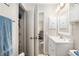 A spacious bathroom featuring an open linen closet, contemporary vanity, and doorway to bedroom at 1622 Navidad St, The Villages, FL 32162