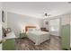 A cozy primary bedroom is furnished with a ceiling fan and light-colored bedding at 1622 Navidad St, The Villages, FL 32162