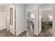 Comfortable primary bedroom featuring wood-look flooring, ensuite bath, and a ceiling fan at 1622 Navidad St, The Villages, FL 32162