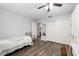 A guest bedroom featuring wood-look flooring and an adjacent bathroom at 1622 Navidad St, The Villages, FL 32162