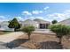 Attractive home with light siding, a garage, a cozy screened porch, and a charming white picket fence at 1622 Navidad St, The Villages, FL 32162