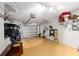 Spacious garage with a pristine epoxy floor featuring a golf cart and ample storage space at 1622 Navidad St, The Villages, FL 32162