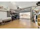 View of a clean, well-lit garage with epoxy floors, a golf cart, and an open garage door at 1622 Navidad St, The Villages, FL 32162