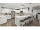 Well-equipped kitchen with stainless steel appliances, white cabinets, and a breakfast bar at 1622 Navidad St, The Villages, FL 32162