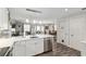 Kitchen with stainless steel dishwasher, and an open floor plan leading to the living and dining rooms at 1622 Navidad St, The Villages, FL 32162