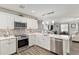 Modern kitchen with stainless steel appliances, stone backsplash, and ample countertop space at 1622 Navidad St, The Villages, FL 32162