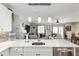 Bright, open kitchen connects to the living area, stainless dishwasher, and quartz countertop at 1622 Navidad St, The Villages, FL 32162