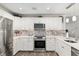 Modern kitchen with stainless steel appliances, subway tile backsplash, and ample cabinet space at 1622 Navidad St, The Villages, FL 32162