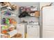 Well-organized laundry room with shelving, storage bins, and a modern washer and dryer at 1622 Navidad St, The Villages, FL 32162