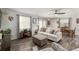 Inviting living room featuring a luxury vinyl plank floor, fan, and comfortable seating with natural light at 1622 Navidad St, The Villages, FL 32162