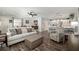 Bright living room featuring a cozy sofa, wood floors, and a modern ceiling fan at 1622 Navidad St, The Villages, FL 32162