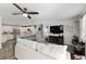 Bright, open concept living room featuring modern ceiling fan and stylish furnishings with views to kitchen at 1622 Navidad St, The Villages, FL 32162