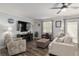 Comfortable living room featuring LVP floors, a ceiling fan, and inviting seating, plus backyard view at 1622 Navidad St, The Villages, FL 32162