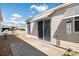 Cozy patio area with space for outdoor seating, and a sliding door entrance at 1622 Navidad St, The Villages, FL 32162