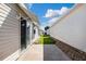 A patio is situated between the house and its neighboring home at 1622 Navidad St, The Villages, FL 32162