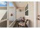 Cozy screened porch with a comfortable seating arrangement and lovely natural light, perfect for relaxation at 1622 Navidad St, The Villages, FL 32162
