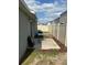 Backyard with a concrete patio, vinyl fence, and well-maintained landscaping at 1721 Nebraska Loop, Sumterville, FL 33585