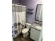 Bathroom with shower, toilet, sink, granite countertop, and open shelving at 1721 Nebraska Loop, Sumterville, FL 33585