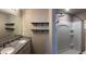 Well-appointed bathroom with double vanity, granite countertops, shelving, and walk-in shower at 1721 Nebraska Loop, Sumterville, FL 33585
