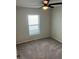 Bright bedroom featuring neutral walls, plush carpet, and ceiling fan at 1721 Nebraska Loop, Sumterville, FL 33585