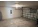 Spacious garage with a garage door and concrete floors at 1721 Nebraska Loop, Sumterville, FL 33585